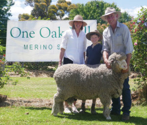 Natasha and Lachlan Wells with Michael Green, "Boudjah"Cooma, holding the top priced ram at the 2018 on-property auction, purchased for $6000